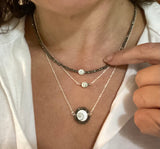 Small evil eye talisman. Eye of Naxos. Shiva shell with black spinel