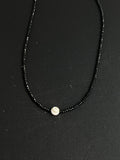 Small evil eye talisman. Eye of Naxos. Shiva shell with black spinel
