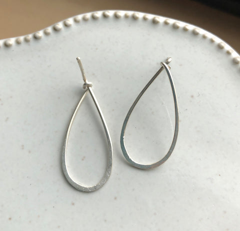 Silver hammered drop shaped earrings. Posts