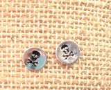 Set of 2 stud earrings. Skulls and evil eye